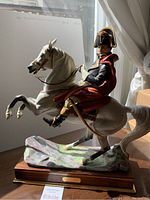 Full left-side view of the porcelain figurine showing Napoleon mounted on a rearing horse on wooden base