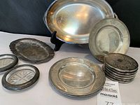 Overview of all pieces: oval dish, plates, embossed coasters, glass-insert coasters