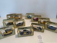 Photo showing the eleven vintage Matchbox Models of Yesteryear toy cars arranged in original boxes showing variety of branding and models.