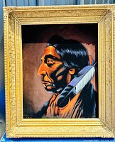 Frontal view of the original Paha Ska velvet painting portrait, showing the subject and ornate gold frame.