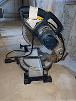 Side view of the Mastercraft compound miter saw showing the blade, motor, and handle.