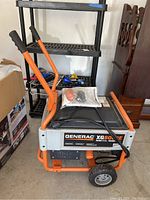 Front angle view showing generator frame, control panel side and manuals on top