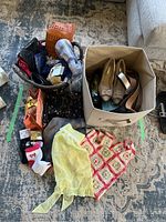 Photo showing assorted women's accessories including size 10 shoes, belts, scarves, socks, and clutches packed together