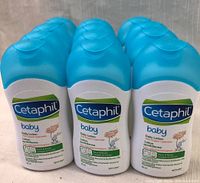Lot of 12 Cetaphil Baby Daily Lotion bottles shown in three rows of four bottles, featuring white plastic bottles with blue caps and labels indicating organic calendula and suitable for face and body.