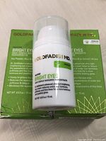 Goldfaden MD Bright Eyes Dark Circle Radiance Concentrate bottle in front of green packaging box showing product name and branding.