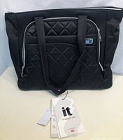 Front view of black it Luggage tote bag with quilted front pocket and attached original tags