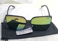 Front view of large square black frame sunglasses with green gradient lenses branded Dior; lens tag and black pouch visible