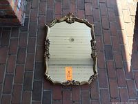 Full view of the rectangular carved gilt mirror showing overall design, shape, and size.