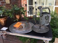 Photo of the galvanized watering can, candle holders, and hammered aluminum plate.