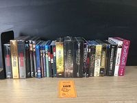 Full array of TV series Blu-ray and DVD sets lined up showing titles like Sopranos, Deadwood, Damages, Downton Abbey, and others.