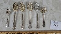 Full set of 6 berry spoons arranged from smallest to largest, showing overall size and design.