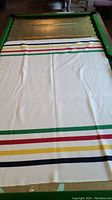 Full view of the Hudson Bay blanket laid out, showing the stripe pattern and overall condition.