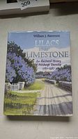 Front cover of Lilacs and Limestone showing illustrated rural scene