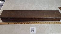 Full length of wooden jewelry box shown alongside a measuring ruler indicating about 32 inches long and 5 inches wide.