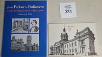 Book titled 'From Parlour to Parliament Sir John A's Kingston House on Rideau Street' by Donna M. Ivey with images of Sir John A. Macdonald and historic buildings on cover, placed next to a vintage-style black and white postcard of Kingston City Hall.