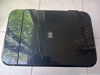 Top view of Canon Pixma MG3120 printer showing top lid with scratches and control panel on the left.