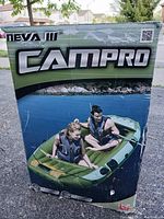 Photo of the box packaging showing Campro Neva III branding and a couple riding the inflatable boat on water.