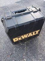Closed DEWALT black plastic tool case with yellow logo and latches, handled for portability.