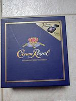 Exterior view of navy blue Crown Royal box with gold trim and branding indicating 2 glasses, 375 ml capacity.