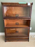 Front view of three-shelf barrister bookcase showing overall design and condition