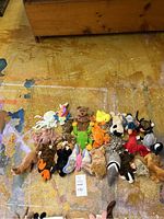 All 23 Ty Beanie Babies arranged on floor showing variety of animals and colors.