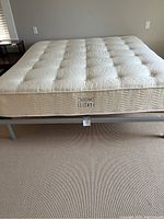 Mattress placed on metal bed frame, showing top and side profile