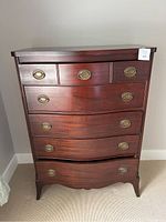 Front view of the wood 5 drawer dresser, showing all drawers and brass handles.
