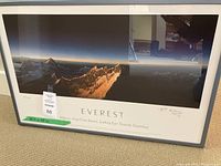 Overall view of framed panoramic print showing mountain scene, white mat and grey frame