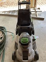 Front view of EGO Power+ cordless mower showing deck, handle and grass catcher bag