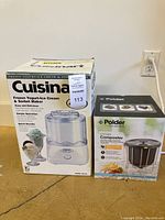 Photo of the boxed Cuisinart Frozen Yogurt-Ice Cream & Sorbet Maker and Polder Kitchen Composter shown side by side.