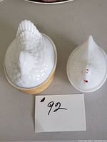 Both hen on nest dishes side by side showing size difference and style