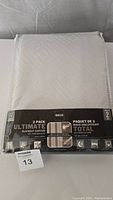 Packed set of 2 blackout curtains in white packaging with black label, showing brand and features.