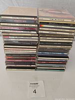 Two stacks of country music CDs showing titles and artists.