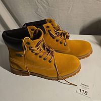 Side view of tan Lugz men's boots showing suede upper, eyelets, laces and padded ankle collar.