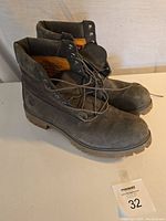 Side angle view of Timberland leather work boots, showing lace up design and sole tread.