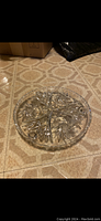 Top view of the round crystal platter showing its starburst and geometric cut patterns.