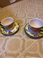 Two sets of Mason's Fruit China cups placed on saucers on a tiled floor, showing overall condition and design
