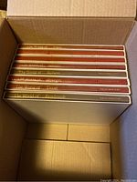 Top view inside box showing 8 art books with titles The World of Durer, Giotto, Rubens, Bruegel, Titian, and Rembrandt