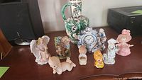 Overview of all 9 handmade Italian ceramic figurines and decorative vase, showing layout and condition