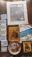 Full display of the 12 items including postcards, plates, magazines, and lithographs.