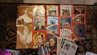 Photo showing the full lot laid out on a carpet, including 13 Time magazines with historical covers, Life magazine, photographic proofs of Clark Gable and Marilyn Monroe, and loose printed pages.