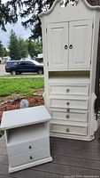 White dresser and side table shown outdoors with visible wear and need for cleaning.