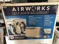 Photo of original Airworks product box listing features such as 4-way directional air control, 3 cooling speeds, adjustable thermostat, easy installation, and compact design.