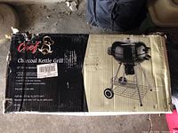 Box front showing brand Master Chef, product name Charcoal Kettle Grill with 22 inch diameter and product features, photo taken to show product details and brand.