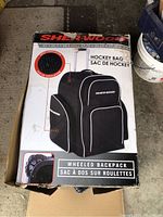 Photo of the Sher-Wood wheeled hockey backpack box showing the product image, description and features including vented water-resistant fabric.
