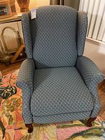 Front view of the manual recliner chair with diamond pattern fabric upholstery.