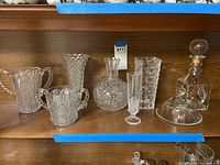 Wide view of all items on shelf showing sugar bowl, vases, decanter, butter dish