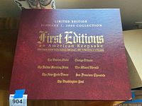 Photo of the top of the collector's box, showing limited edition January 1, 2000 collection with names of included newspapers in gold text on red background.