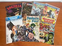 Overview photo of 8 comic books including Dogzilla, Wizards, Justice League America Rebirth, Fantastic Four, and Marvel Saga