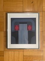 Framed lithograph print showing the full artwork and frame on parquet floor background.